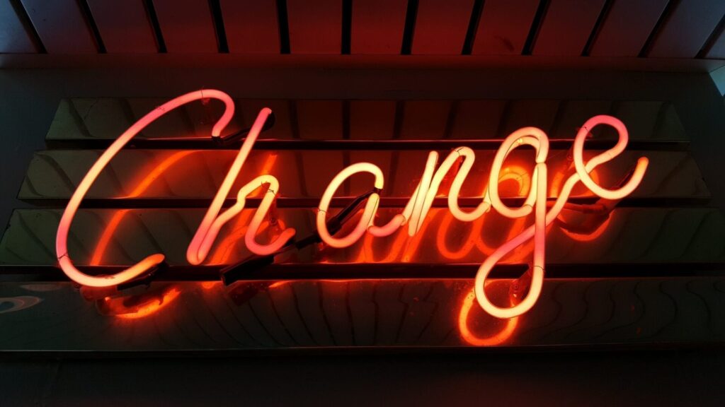 neon light change sign that highlights the need for better protection of women & children against domestic violence