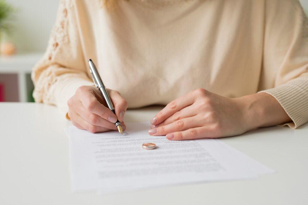 woman about to sign divorce application prepared by a competent divorce lawyer in Ipswich