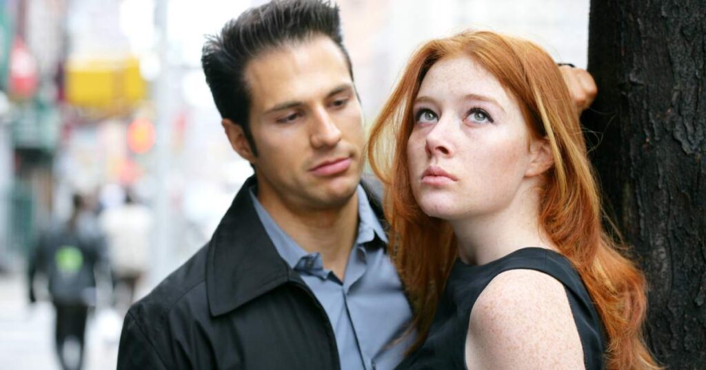 man staring at a woman who is looking upwards